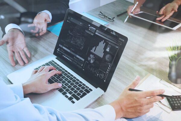 Laptop and documents on the table while having a meeting