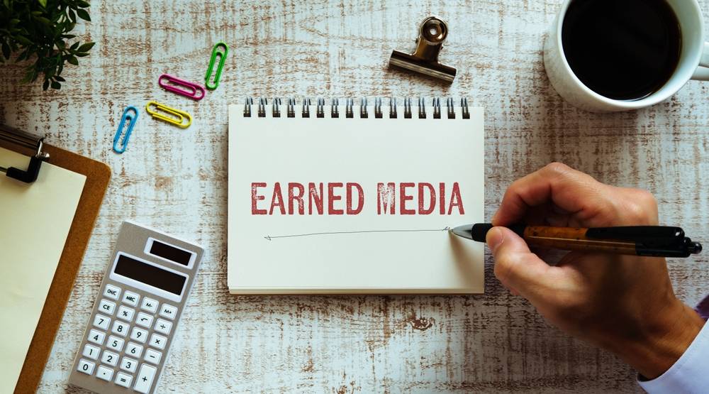 notebook with the words earned media written